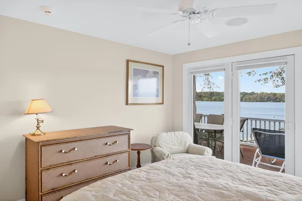 a bedroom with a bed and a dresser next to a window
