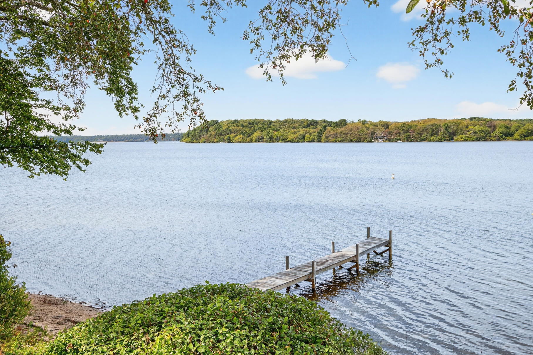 10 Brian Way Harwich, MA 02645 - Photo 65 of 75 a view of a lake with lawn chairs