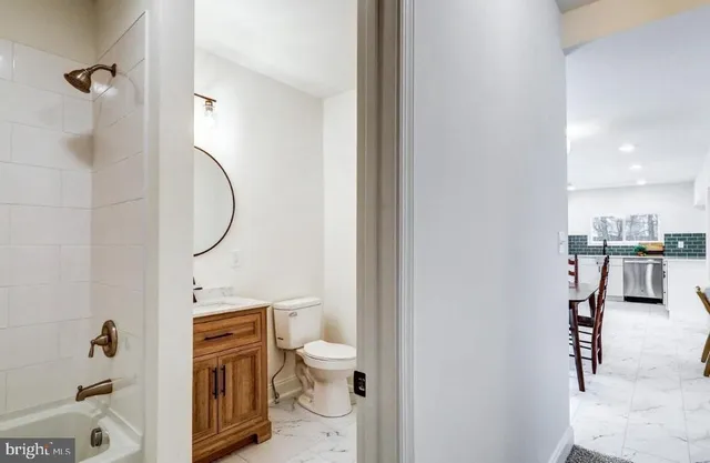 a bathroom with a toilet sink and shower