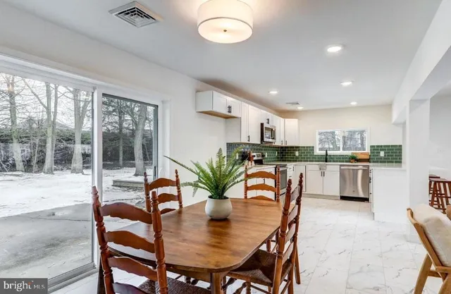 a dining room with furniture and window