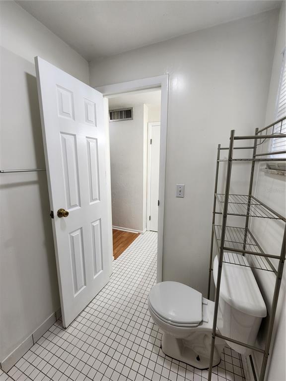 719 Southwest 75th Street, Unit 103 Gainesville, FL 32607 - Photo 12 of 28 a bathroom with a toilet and a shower
