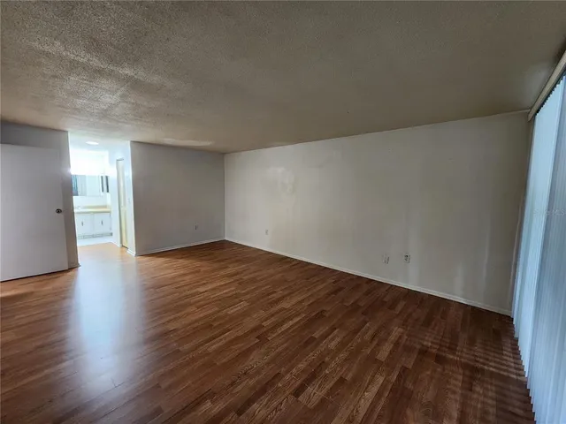 a view of an empty room and wooden floor