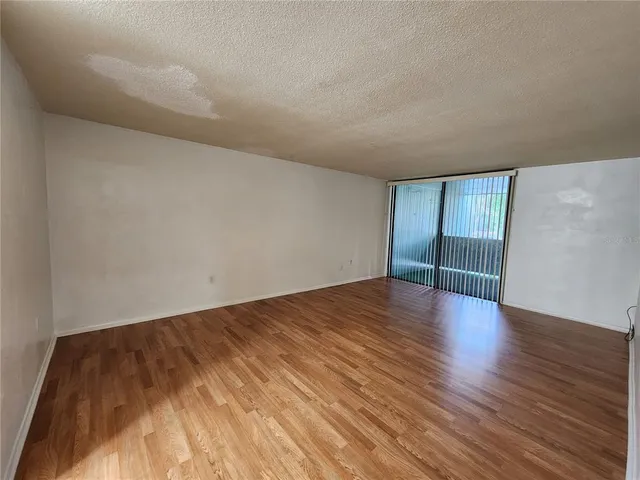 a view of an empty room and wooden floor