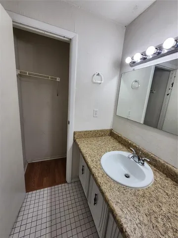 a bathroom with a sink a vanity and a mirror