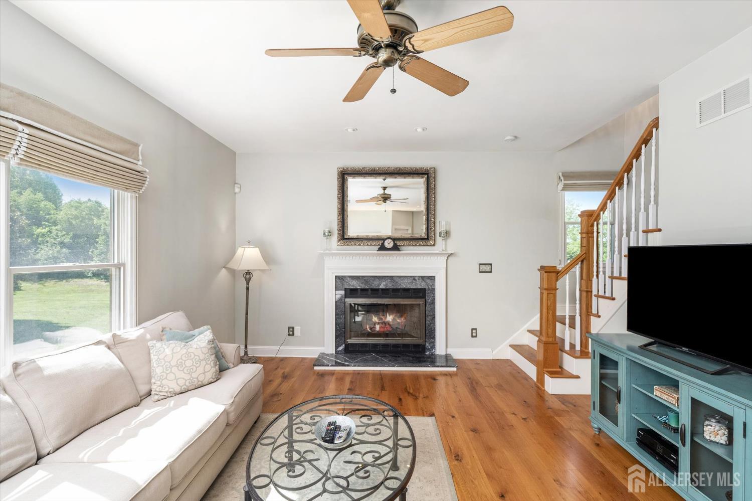 63 Iron Bridge Road Hamilton, NJ 08620 - Photo 11 of 48 a living room with furniture fireplace and flat screen tv