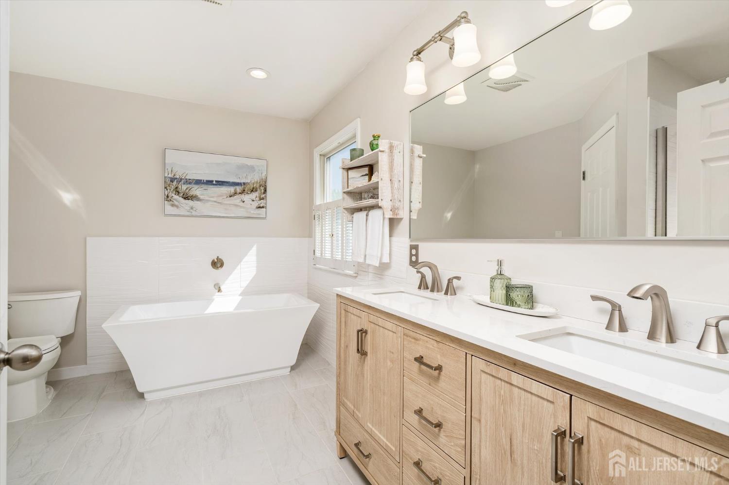 63 Iron Bridge Road Hamilton, NJ 08620 - Photo 24 of 48 a spacious bathroom with a double vanity sink mirror and bathtub