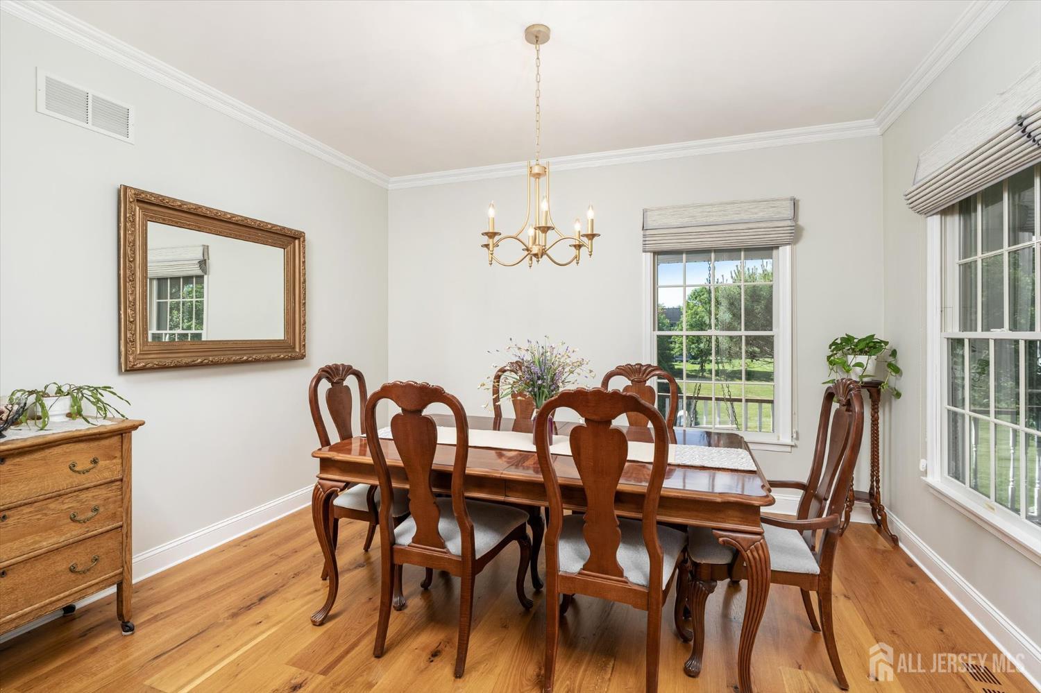 63 Iron Bridge Road Hamilton, NJ 08620 - Photo 3 of 48 a view of a dining room with furniture a chandelier and wooden floor