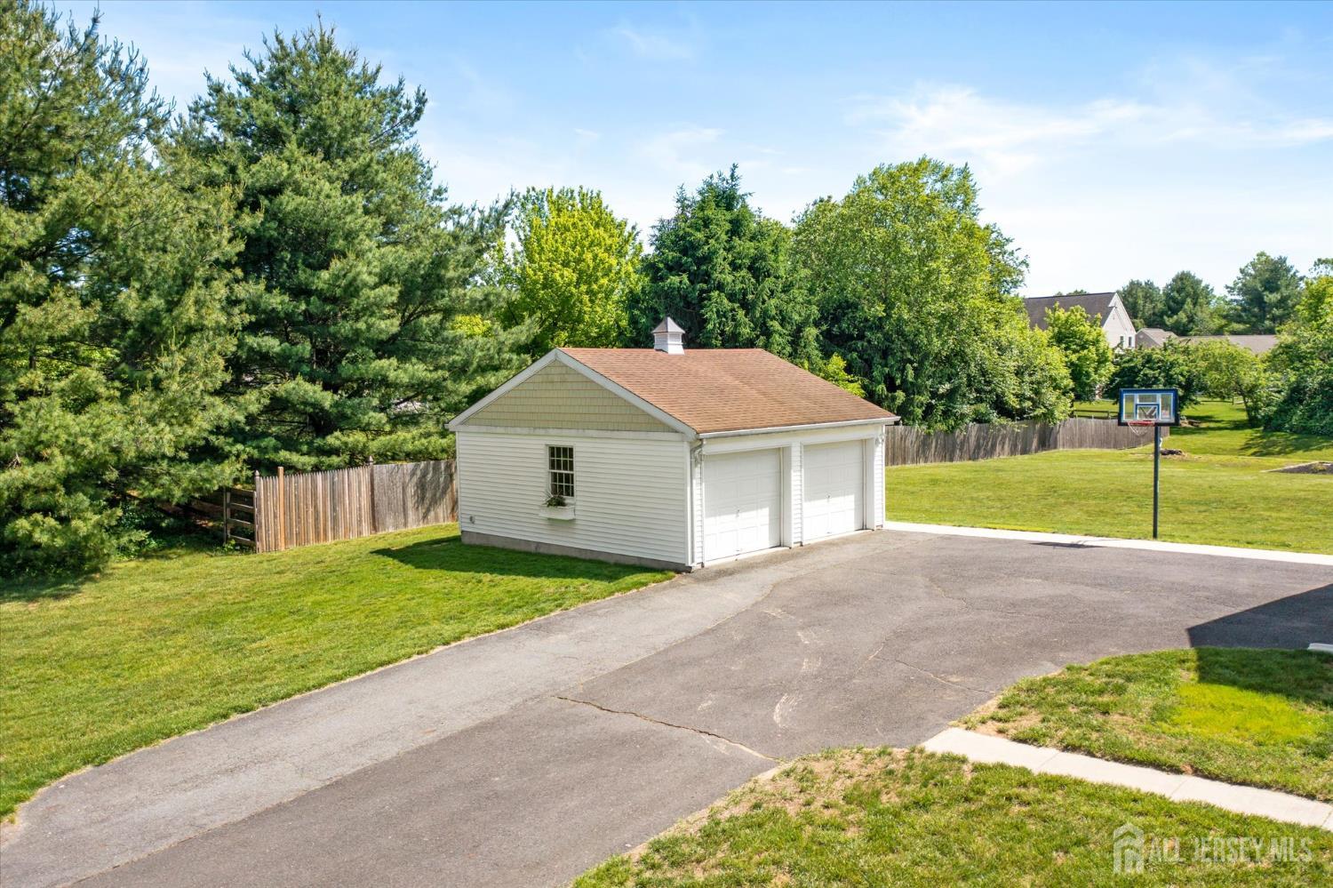 63 Iron Bridge Road Hamilton, NJ 08620 - Photo 48 of 48 a front view of a house with a yard and garage