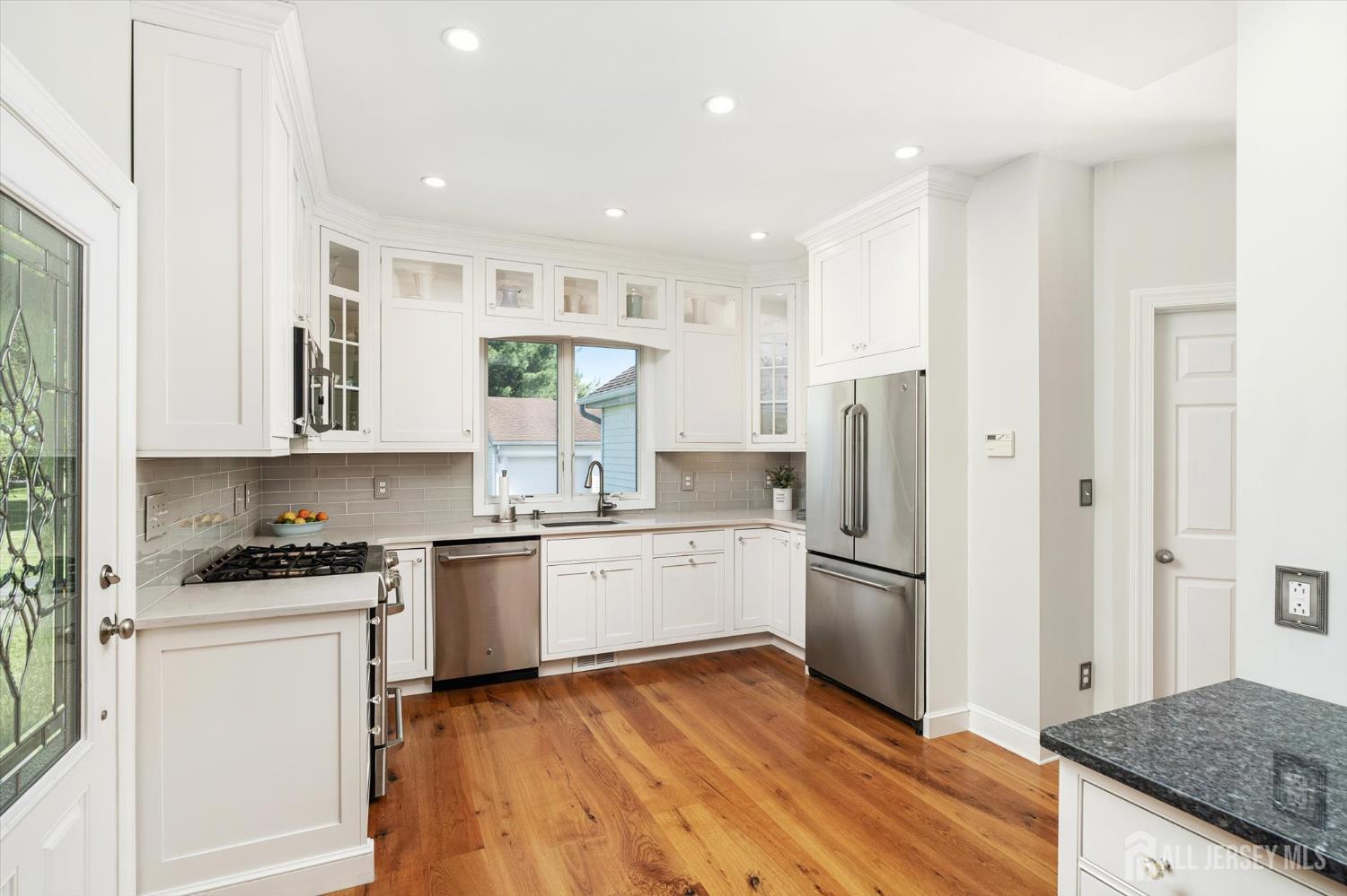 63 Iron Bridge Road Hamilton, NJ 08620 - Photo 6 of 48 a kitchen with a stove a sink and a refrigerator