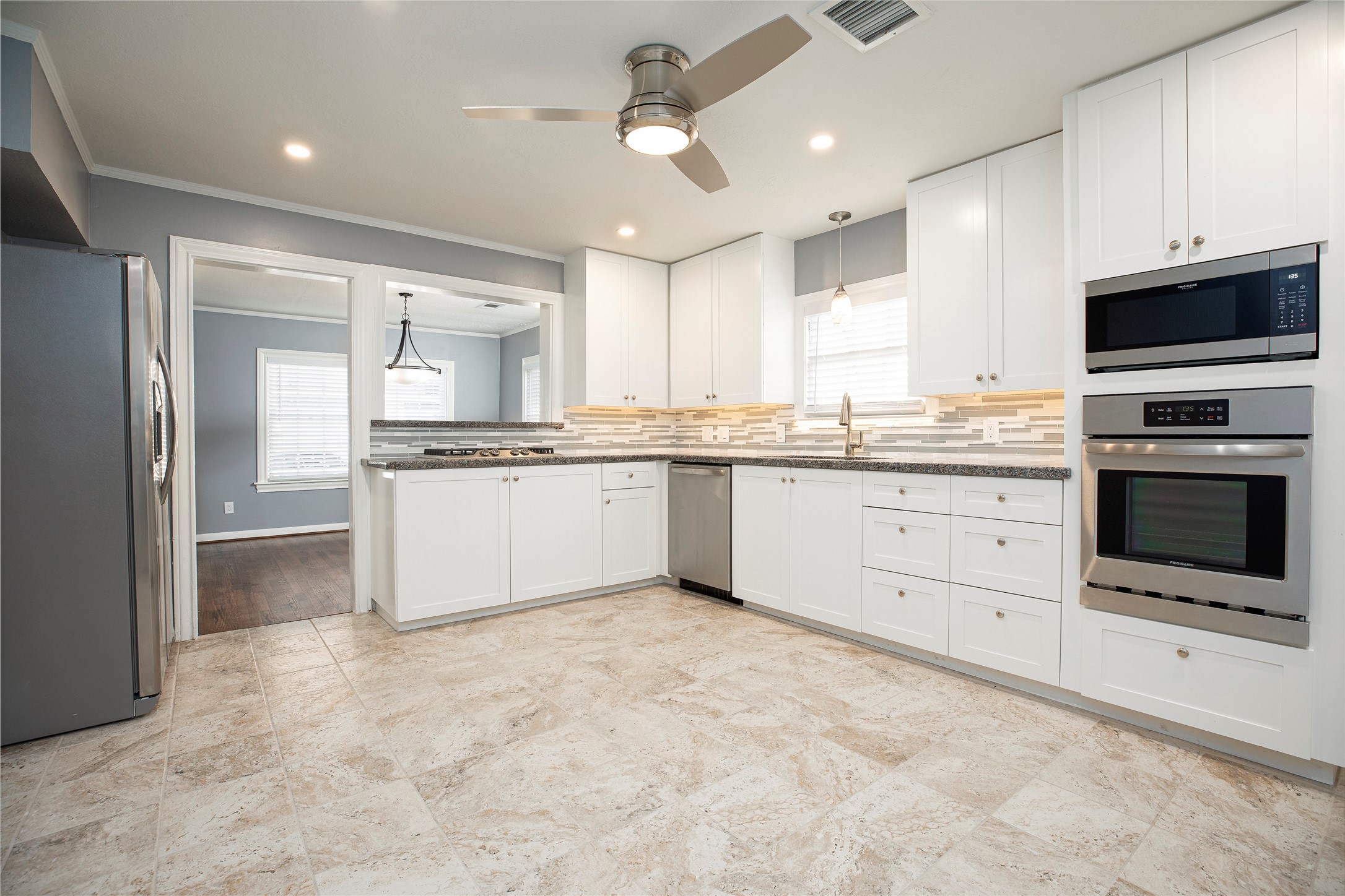 1202 Birdsall Street Houston, TX 77007 - Photo 9 of 30 a kitchen with stainless steel appliances granite countertop a stove top oven a sink and a refrigerator