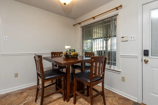 a dining room with furniture and window