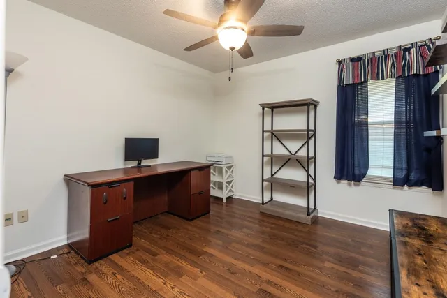 a living room with wooden floor and furniture