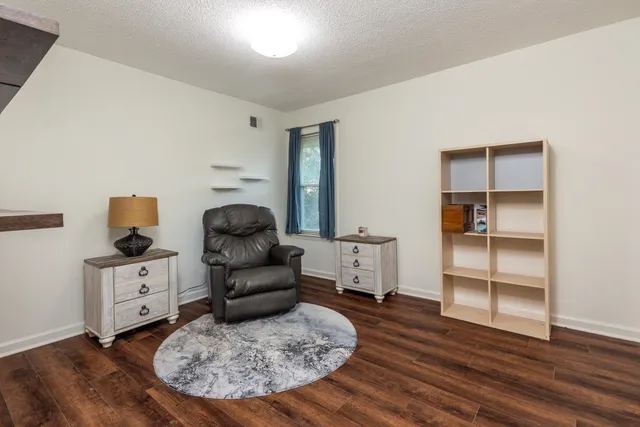 a living room with furniture and wooden floor