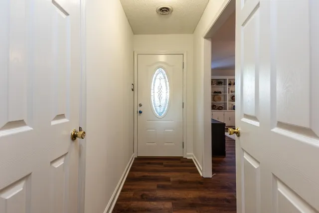 a view of hallway with wooden floor