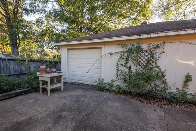 a backyard of a house with table and chairs