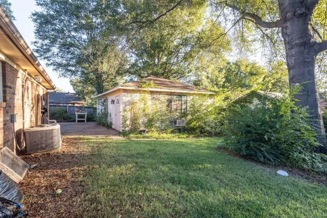 a backyard of a house with table and chairs