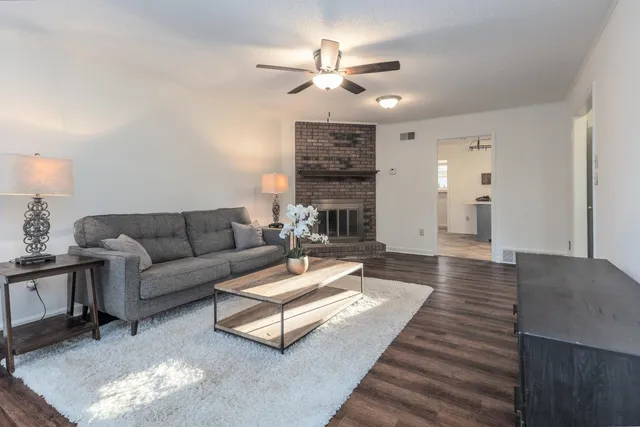 a living room with furniture and a chandelier