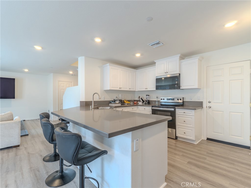 25602 Pne Rdg Road Homeland, CA 92548 - Photo 8 of 35 a kitchen with a sink cabinets and wooden floor