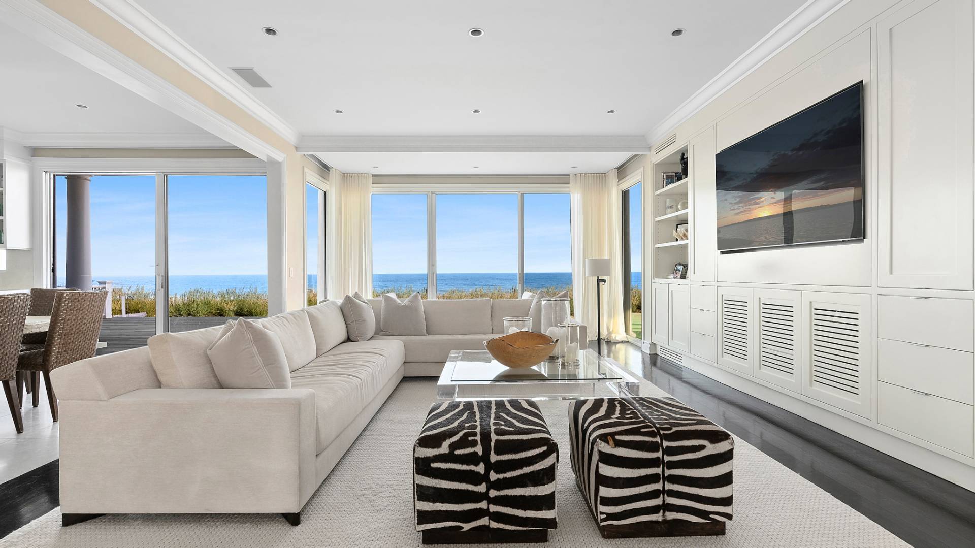 21 Surfside Drive Bridgehampton, NY 11932 - Photo 9 of 25 a bedroom with a balcony a bed and a flat screen tv