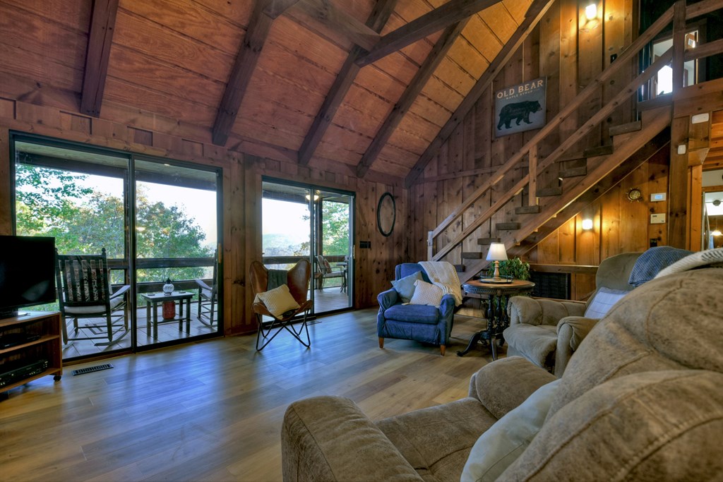 392 Eagles Nest Mountain Road Blue Ridge, GA 30513 - Photo 12 of 51 a living room with furniture floor to ceiling window and wooden floor