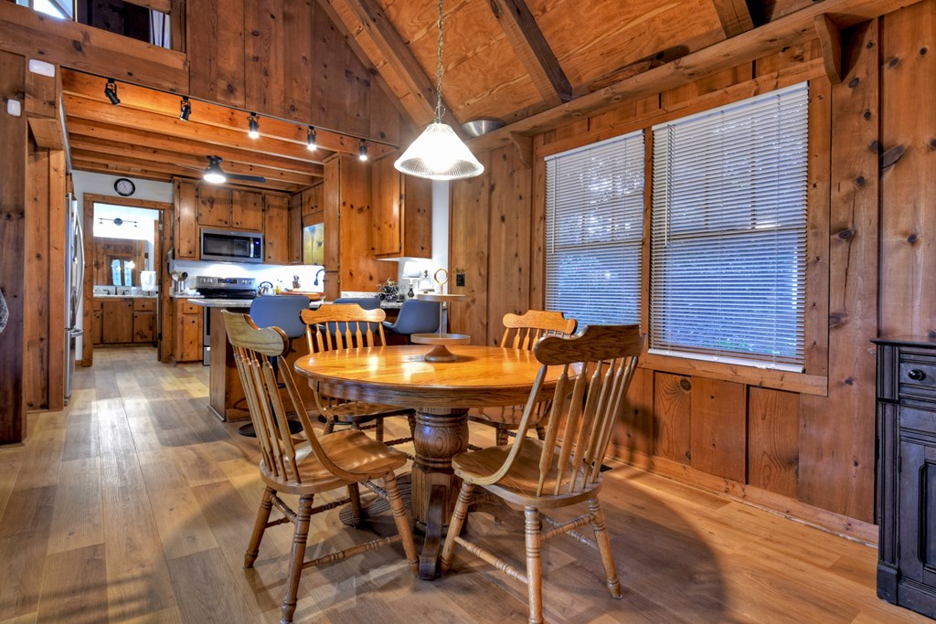 392 Eagles Nest Mountain Road Blue Ridge, GA 30513 - Photo 14 of 51 a view of a dining room with furniture wooden floor and chandelier