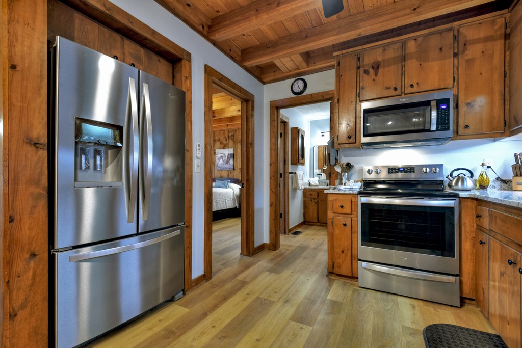 392 Eagles Nest Mountain Road Blue Ridge, GA 30513 - Photo 18 of 51 a kitchen with stainless steel appliances granite countertop a refrigerator stove and microwave