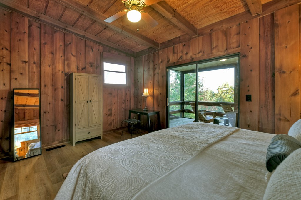 392 Eagles Nest Mountain Road Blue Ridge, GA 30513 - Photo 30 of 51 a bedroom with a bed and large windows