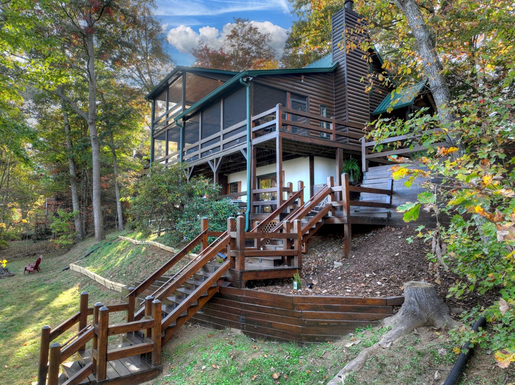 392 Eagles Nest Mountain Road Blue Ridge, GA 30513 - Photo 47 of 51 a view of a wooden deck with chairs and a large tree