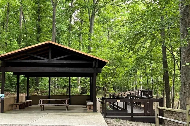 a view of a roof deck with table and chairs under an umbrella