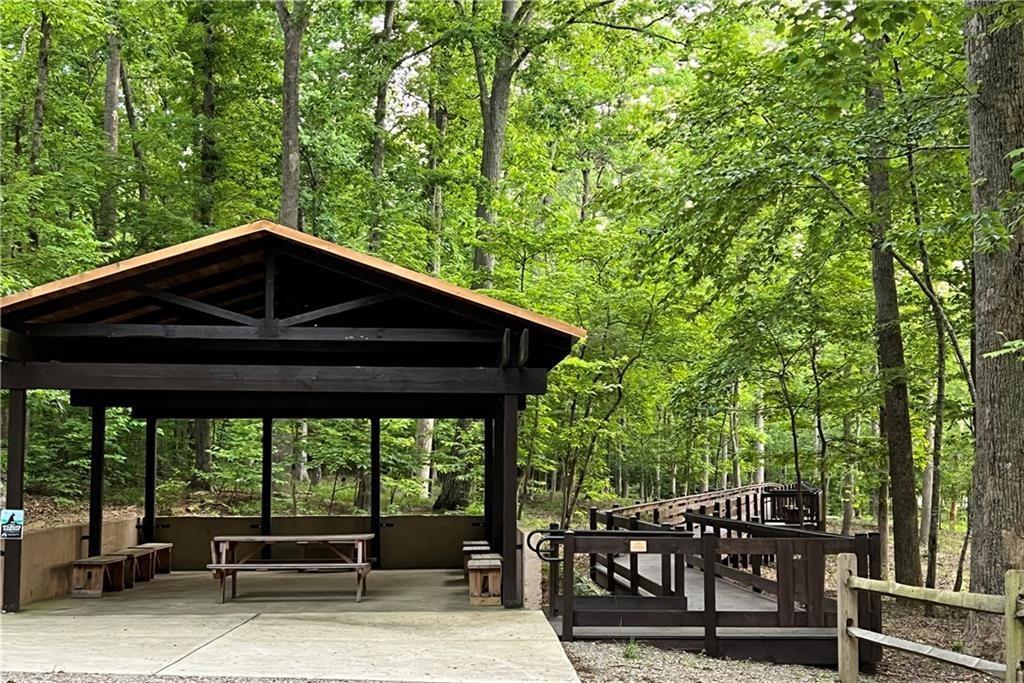 267 Starcross Lane Jasper, GA 30143 - Photo 19 of 46 a view of a roof deck with table and chairs under an umbrella