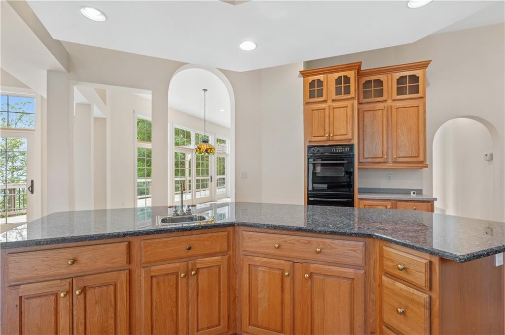 267 Starcross Lane Jasper, GA 30143 - Photo 23 of 46 a kitchen with stainless steel appliances granite countertop a stove and a sink