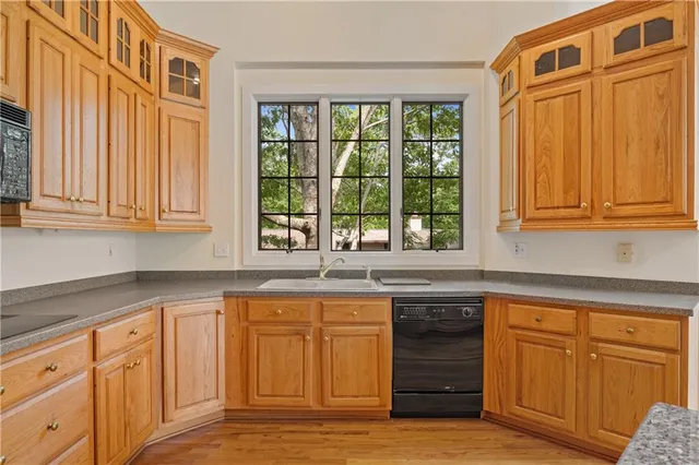 a kitchen with wooden cabinets and a sink