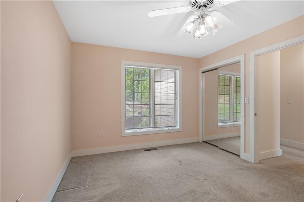 267 Starcross Lane Jasper, GA 30143 - Photo 30 of 46 an empty room with chandelier fan and windows