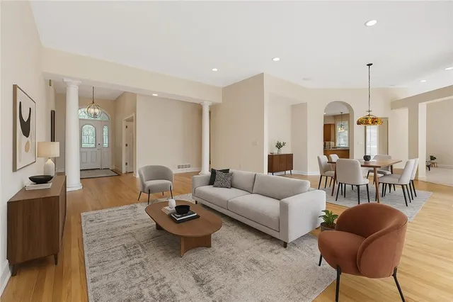 a living room with furniture a table and a chandelier