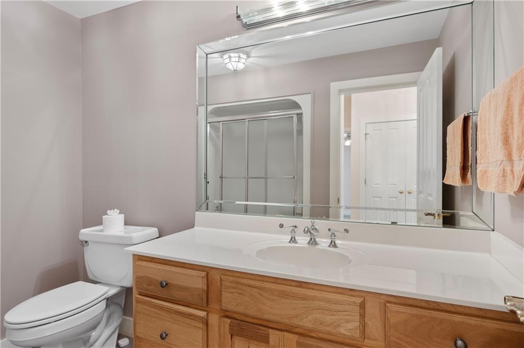 267 Starcross Lane Jasper, GA 30143 - Photo 32 of 46 a bathroom with a sink a toilet and a large mirror