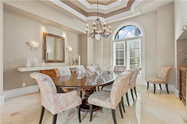 a view of a dining room with furniture and a chandelier