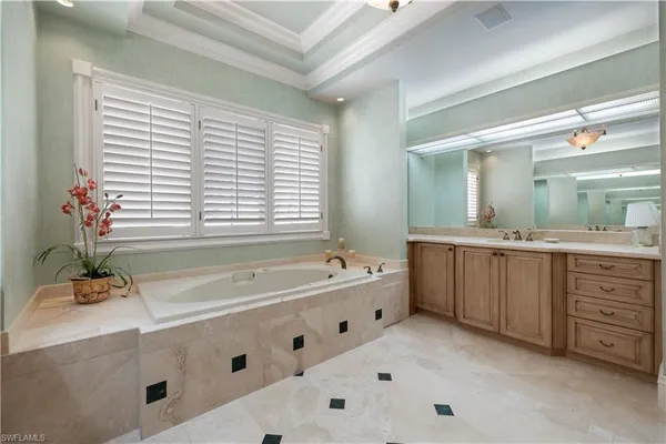 a bathroom with a bathtub sink and mirror