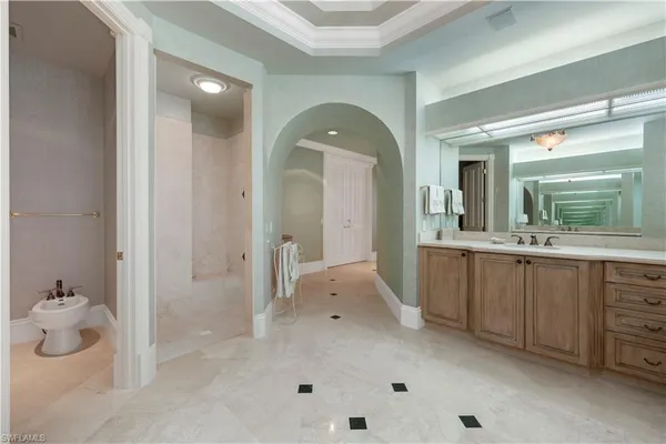 a spacious bathroom with a granite countertop sink and a mirror