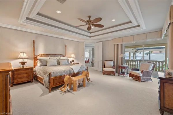 a spacious bedroom with a bed and a chandelier