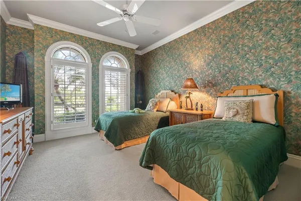 a bedroom with 2 bed and a large mirror