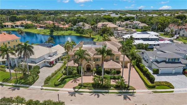 an aerial view of residential houses with outdoor space and lake view
