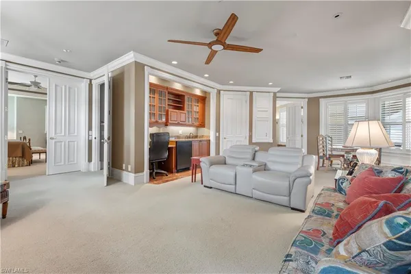 a living room with furniture and a chandelier