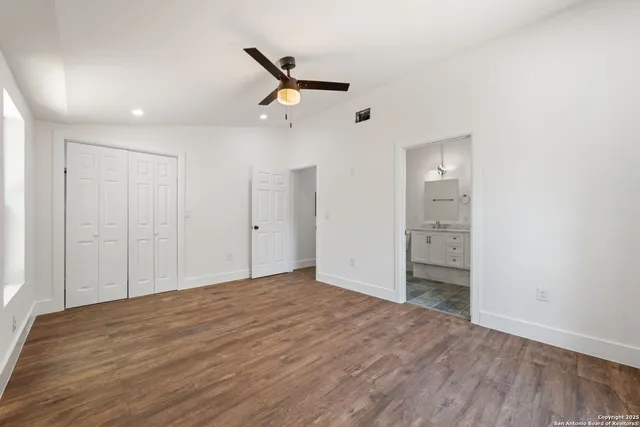 a view of empty room with wooden floor