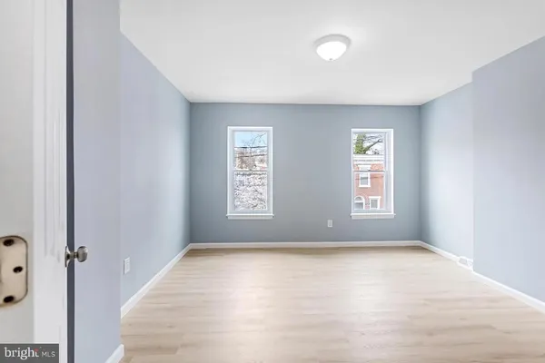 an empty room with windows and closet