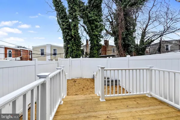 a view of a balcony with wooden floor and fence