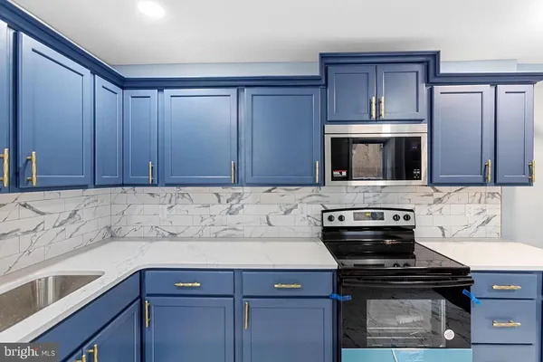 a kitchen with a stove and a microwave