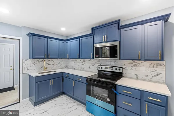 a kitchen with a sink stove and microwave