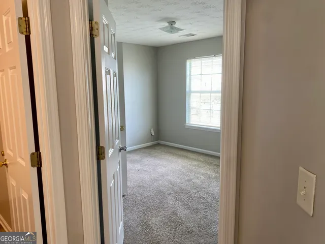 an empty room with wooden door