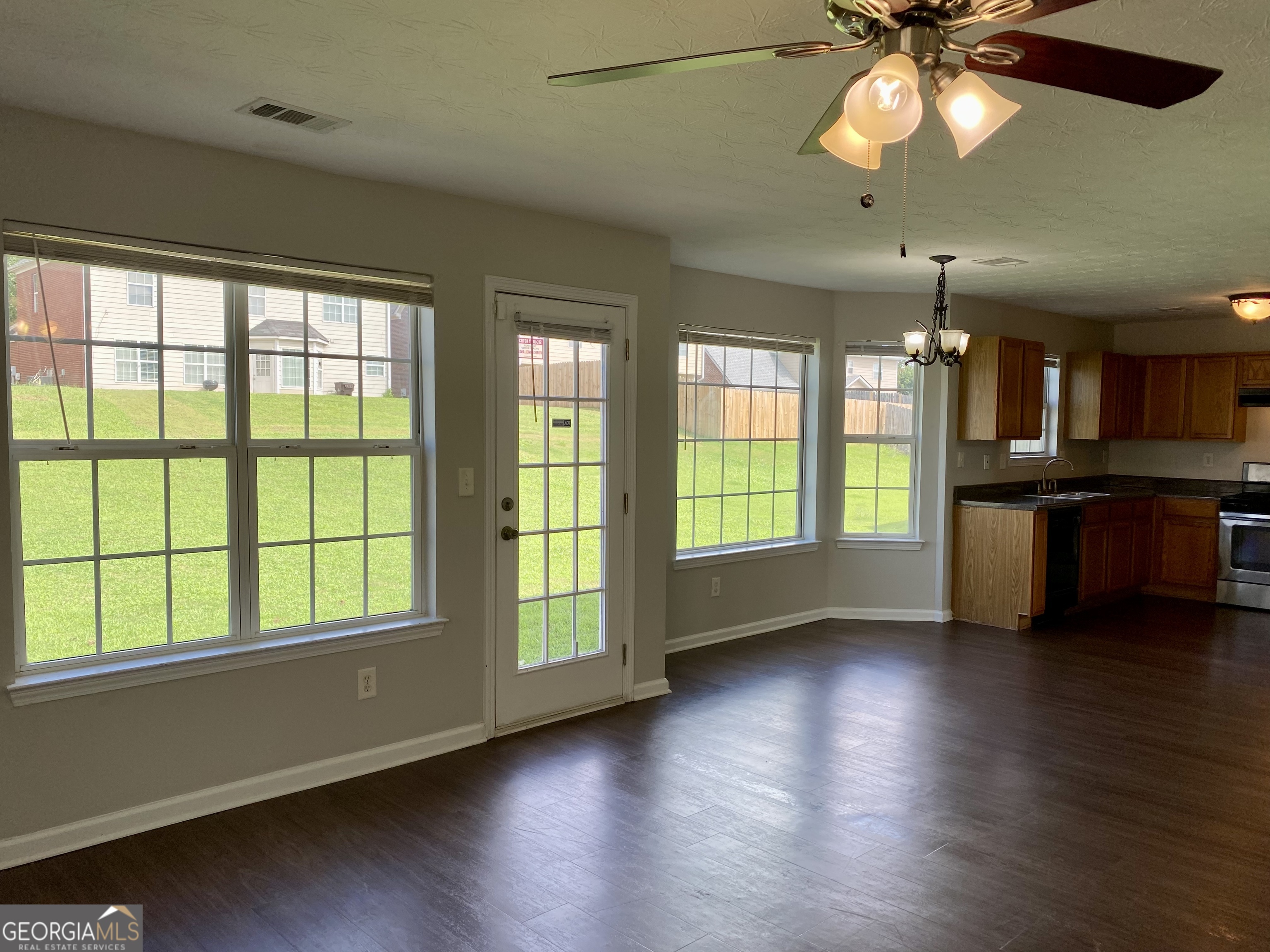 456 Parkside Way McDonough, GA 30253 - Photo 10 of 14 a view of an empty room with window and wooden floor