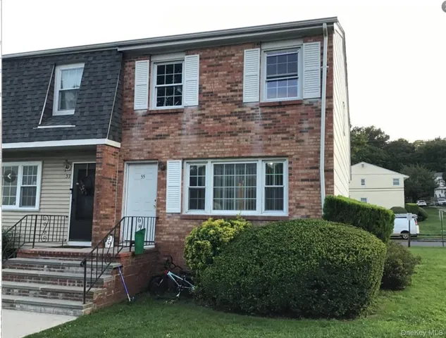 a view of a house with a yard and plants
